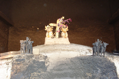 an oven with the typical roof adornment of a cross, bulls and containers