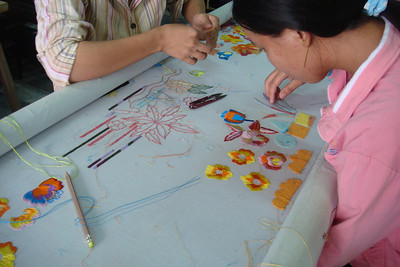 women working on embroidery for the tailor-made clothes