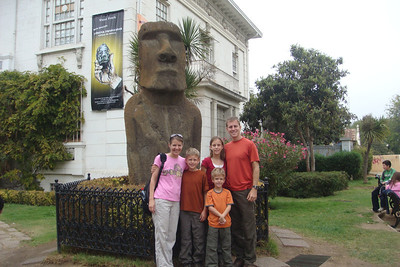 posing in front of an Easter Island Moia statue