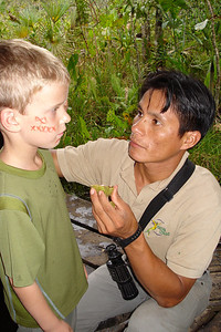 Ivan painted the faces of the kids with a fruit he found