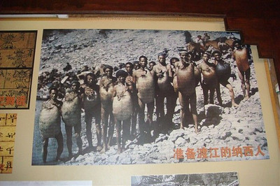 a picture of some men waiting to cross the river with their inflated sheep bladders