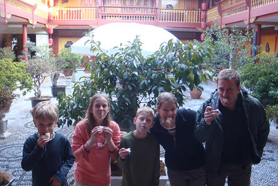 trying the poofy, chewy, stringy candy we bought off the street