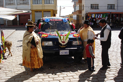 some women in bowler hats dedicating a car