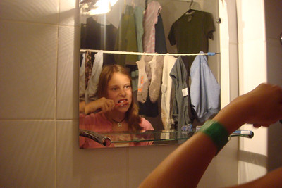 Alayna parting the socks to brush her teeth