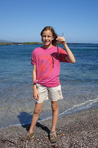 Alayna holding a red mangrove seed, they can grow roots in salt water