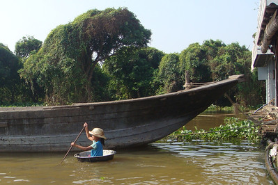 a little girl using a metal bowl as a tender boat