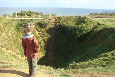Benji studying a crater on Pont du Hoc