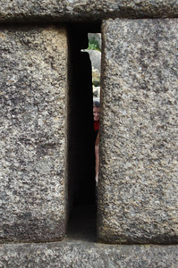 Meredith posing through a crack in the wall