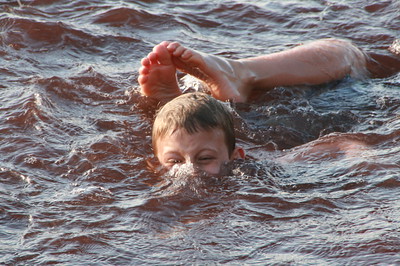 Nate playing in the red waters of the beach on Rubina
