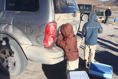 Gonzalo showed Benji how to warm his hands on the side of the car warmed by the sun