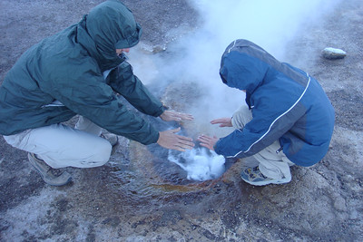 Clay and Nate warming their hands in the steam