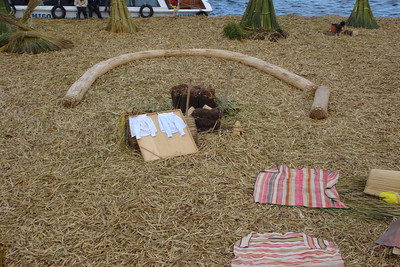 the rolled reeds serve as benches around a small fire