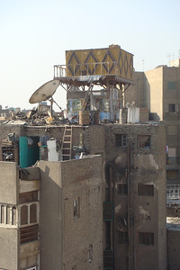 a pigeon house perched on top of an apartment building