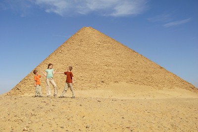 posing in front of the red pyramid