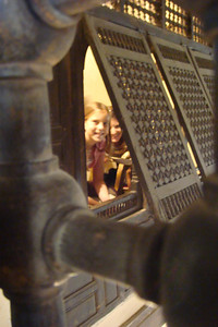 peeking out of the secret room where women could see but not be seen